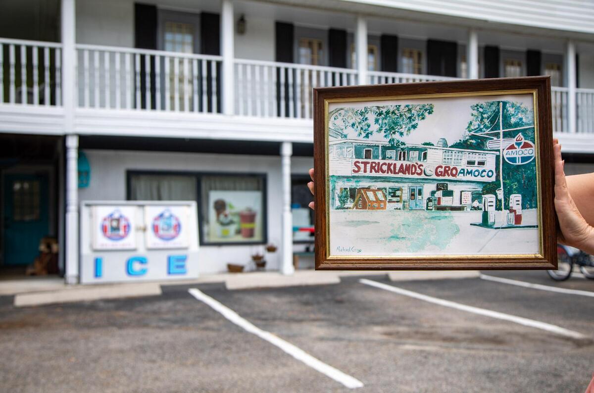 Murrells Inlet General Store owner Jennifer Watkins holds a hand-drawn photo of the store from over 50 years ago.