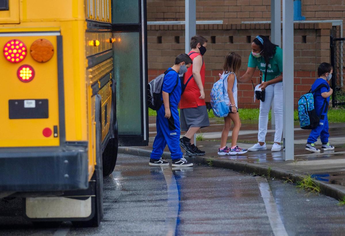 Students arrive at Homewood Elementary via bus on Tuesday. In-person classes resumed today in Horry County Schools. While many teachers, parents and students expressed excitement at being back, some are concerned the the latest spike of COVID-19 cases in South Carolina and what that might mean for the 2021-2022 school year. Aug. 11, 2021.