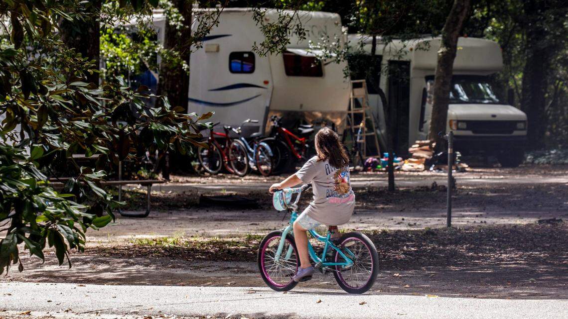 A girl rides her bike through the camp ground at Myrtle Beach State Park. Sept. 4, 2024.
