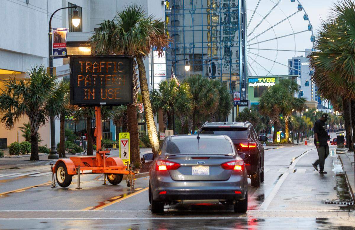 A sign reminds drivers of adjusted one-way traffic patterns on Ocean Boulevard. The practice known as “flushing” closes the Northbound lane of traffic to all except emergency vehicles. Downtown Myrtle Beach’s tourist district was relatively quiet for a Summer evening on Ocean Boulevard and the Boardwalk. Storms put a damper on the evening activities but as the skies cleared, visitors returned to enjoy the attractions. Friday, May 30, 2025.