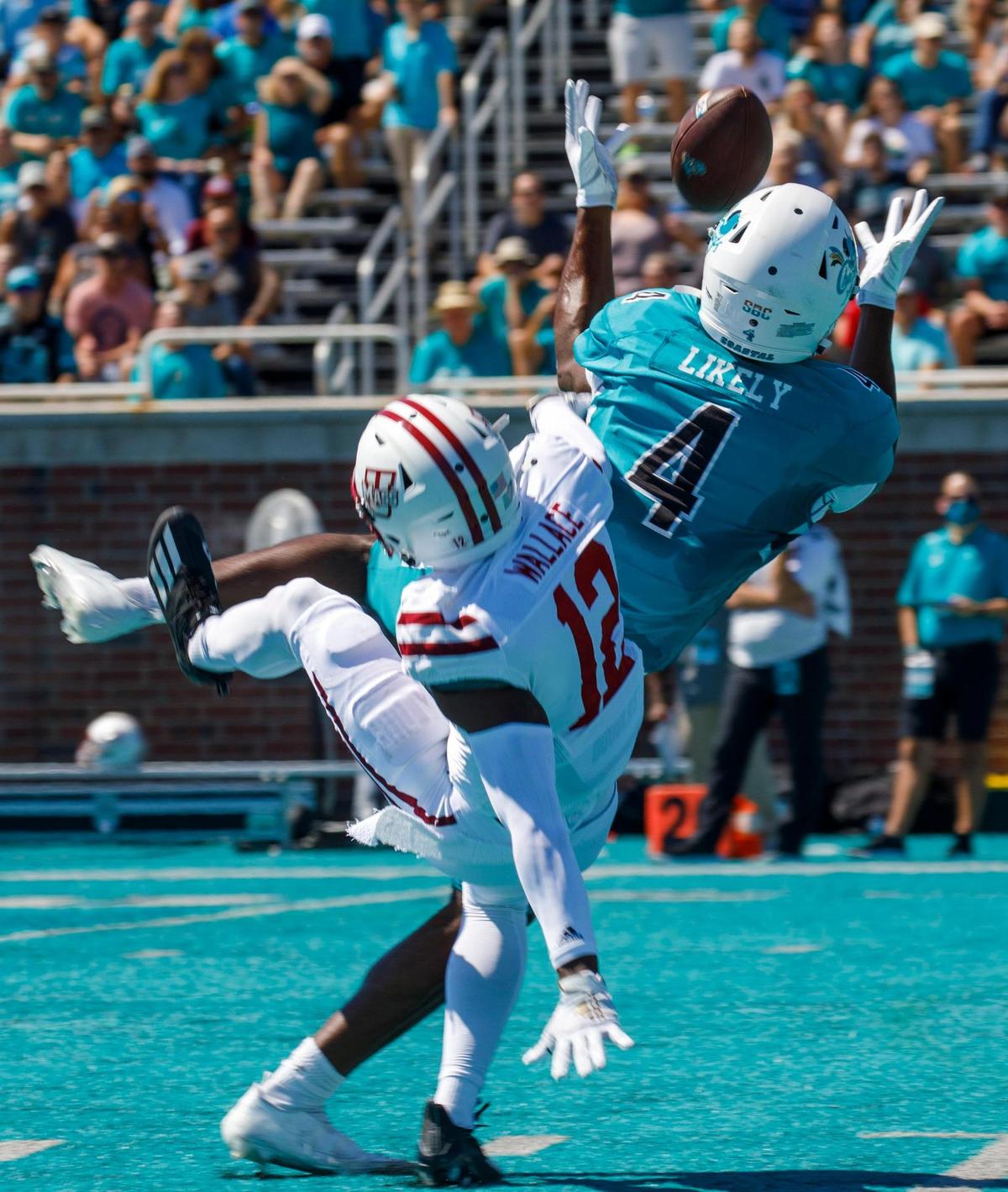 Coastal’s Isaiah Likely receives a pass after being interfered with by U.Mass’ Josh Wallace. Coastal Carolina, ranked 17, defeated Massachusetts on Saturday at Brooks Stadium in Conway SC. Spectators were encouraged to wear teal for a “teal out” promotion. Aug. 11, 2021.
