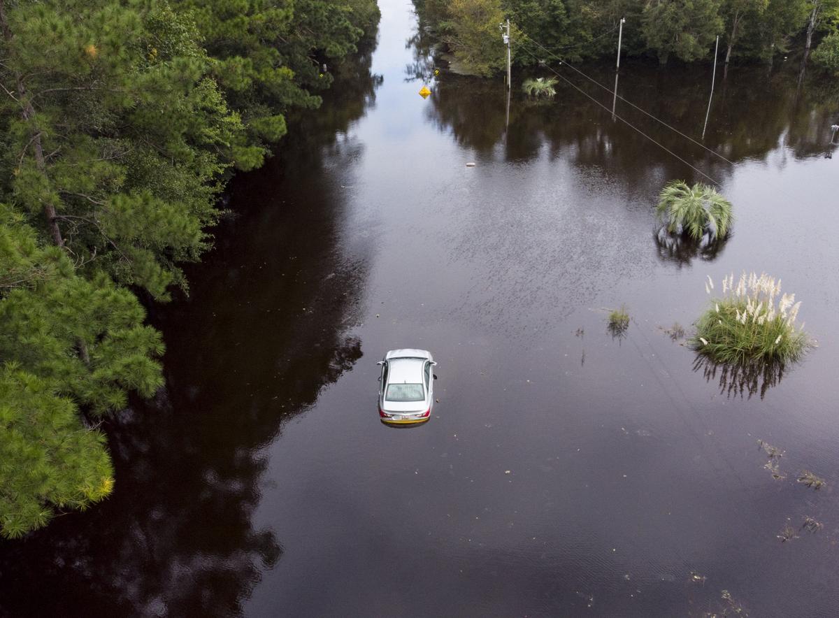 A car sits flooded in the middle of S.C.905 in The Red Bluff community. Red Bluff flooded along the Waccamaw River and Simpsons Creek under Hurricane Florence’s deluge with entire neighborhoods underwater. Monday, Sept. 24, 2018.