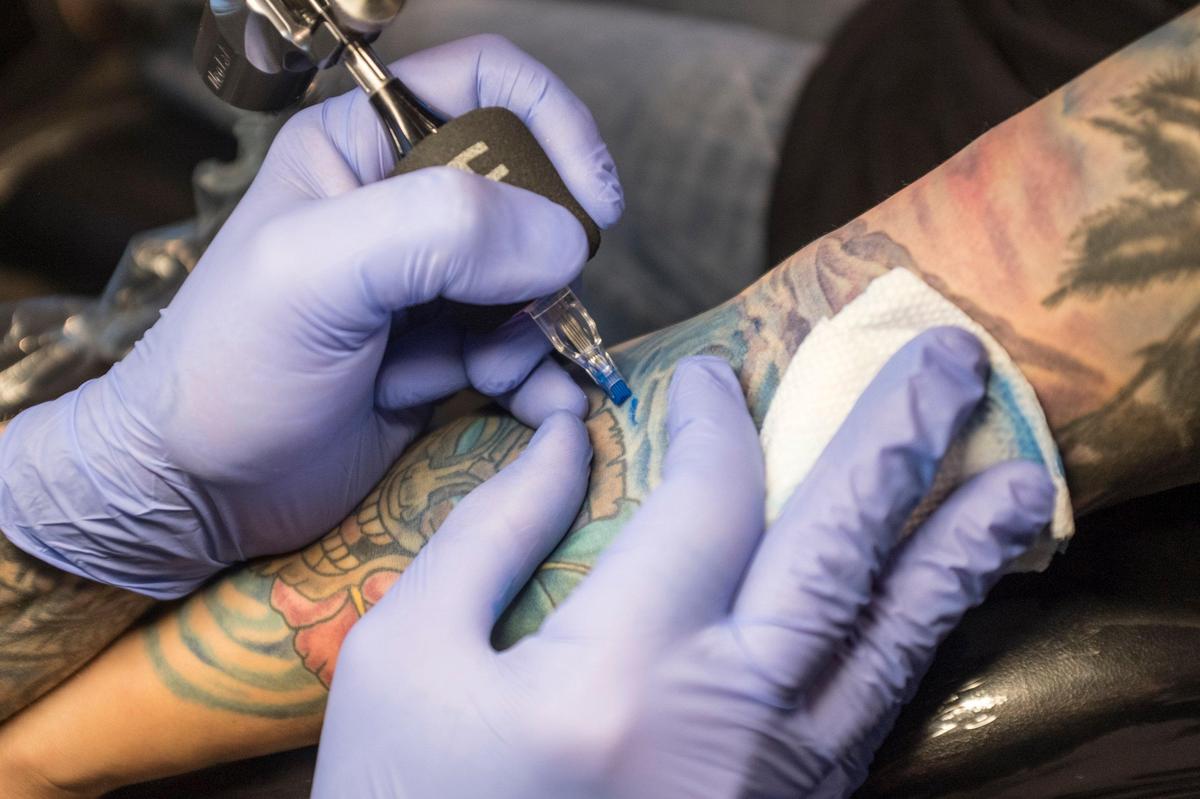 Richard Lanz, co-owner of Elite Ink Tattoos works on a Kassie Hawse’s Hawaiian themed tattoo. Lanz owns one of over a dozen tattoo shops on Seaboard Street and explained that Myrtle Beach city zoning laws regulate shops like his to industrial areas. Dec 10, 2018.