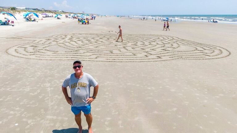 Sunset Beach Maze Man has captivated vacationers and locals. How he makes his sand designs