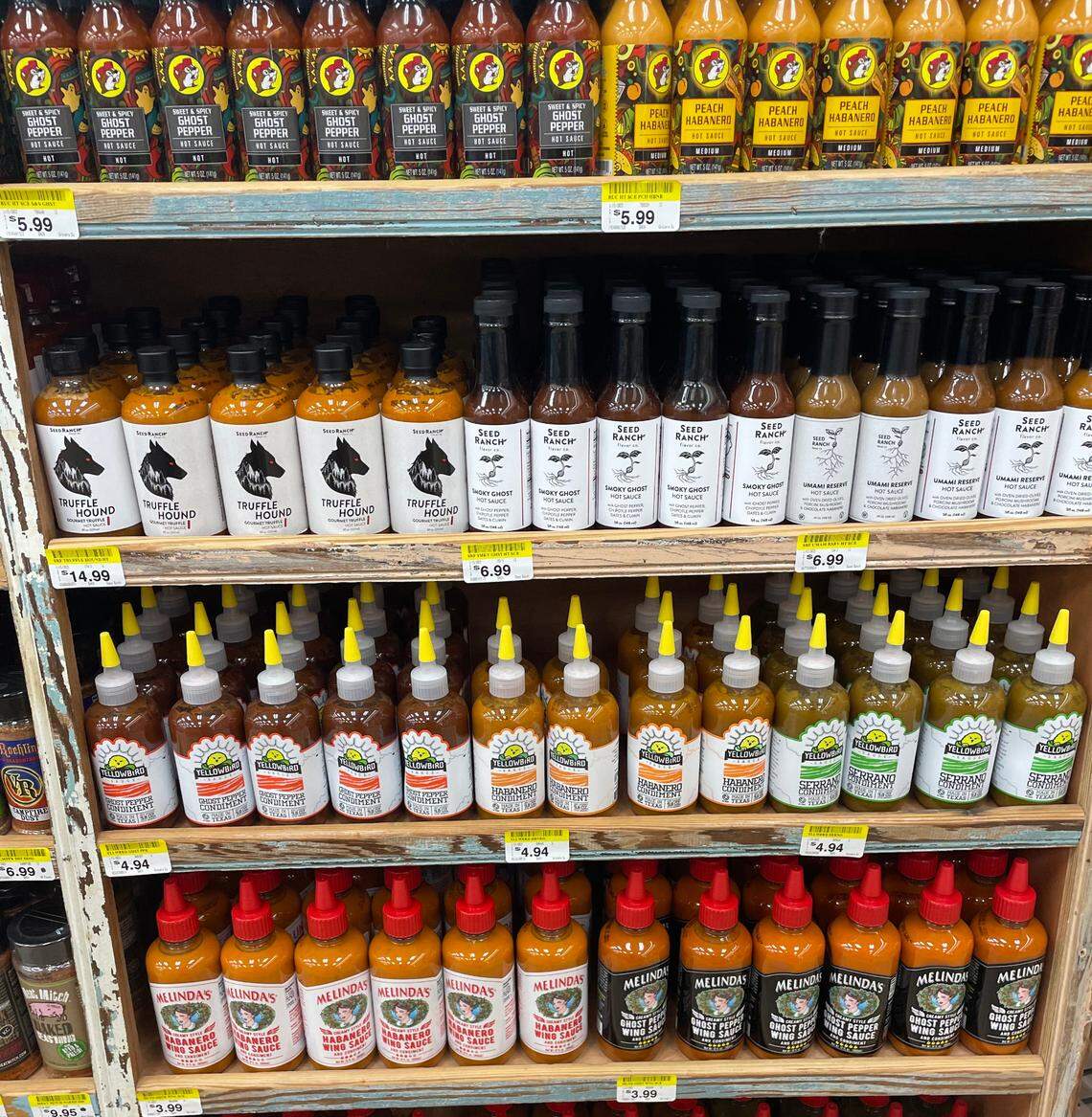 Hot sauces sold at a Buc-ee’s in Royce City, Texas, featuring some produced by the gas station itself and other brands from Texas.