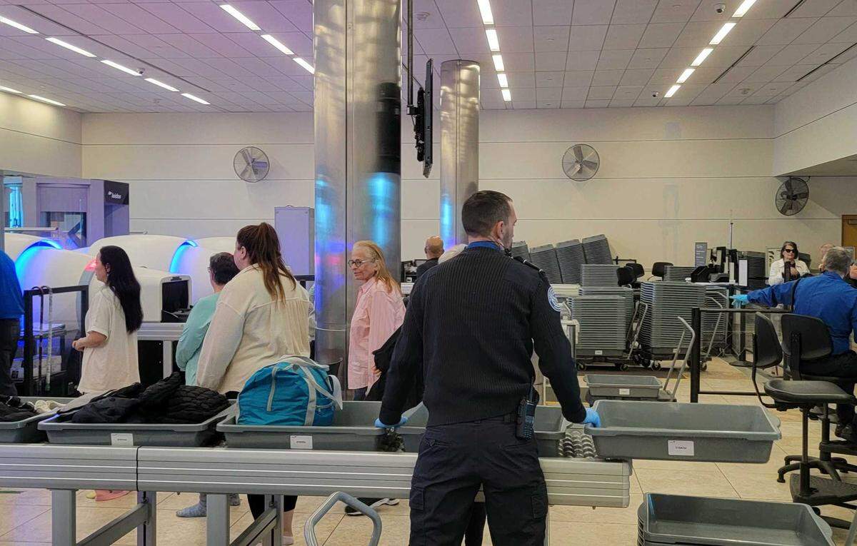 A Transportation Security Administration agent supervises travelers at the Myrtle Beach International Airport security checkpoint on Feb. 25, 2025.