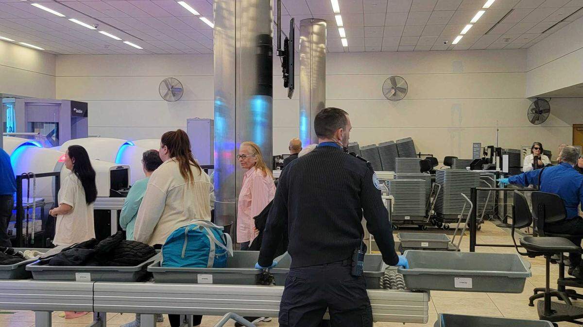 A Transportation Security Administration agent supervises travelers at the Myrtle Beach International Airport security checkpoint on Feb. 25, 2025.
