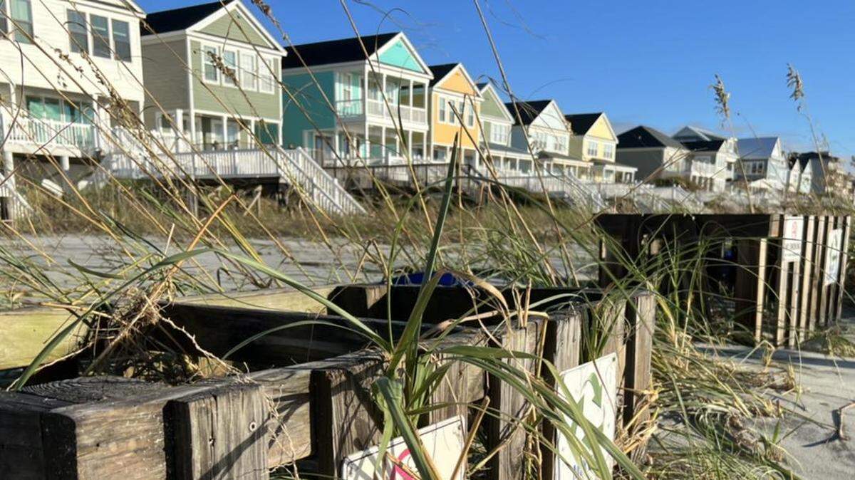 Crews in Surfside Beach pick up debris and clear swashes following Hurricane Ian’s arrival Friday in South Carolina.