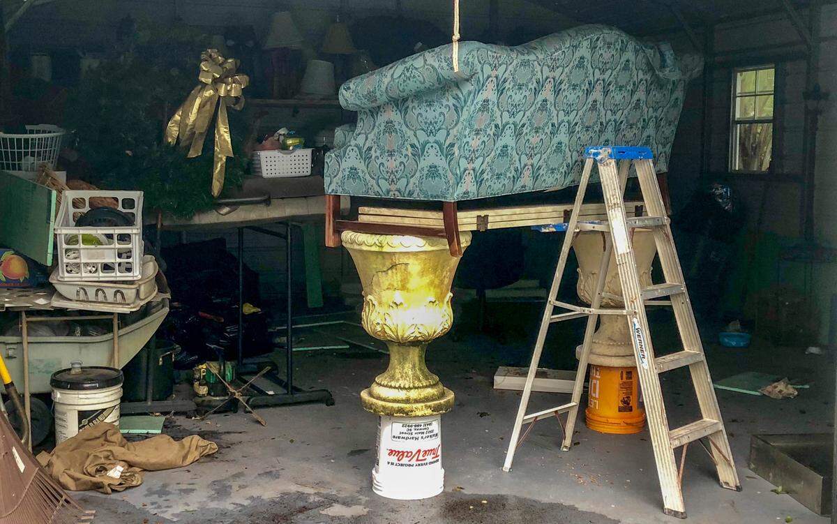 A couch sits propped up on buckets and flower pots Sunday in preparation for the flood waters of Tropical Depression Florence, which are expected to arrive this week.