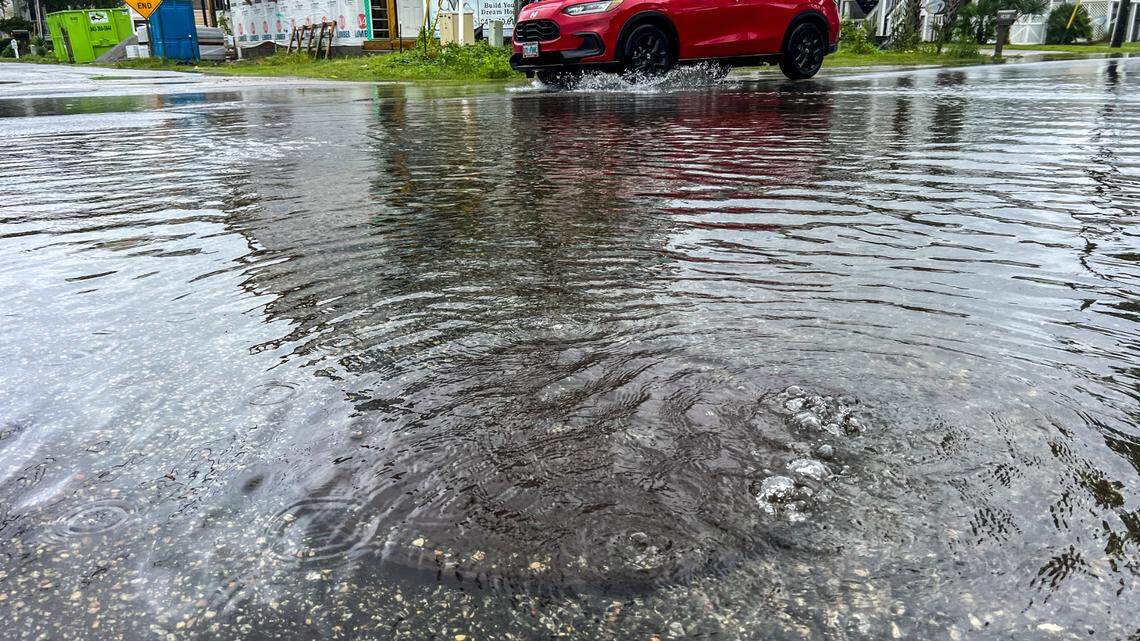 Flood waters cover man hole covers on Duffy Street in North Myrtle Beach. Tropical Storm Debby continued to impact the Myrtle Beach area on Wednesday with bands of wind and flooding rain moving across the area. Aug. 7, 2024.