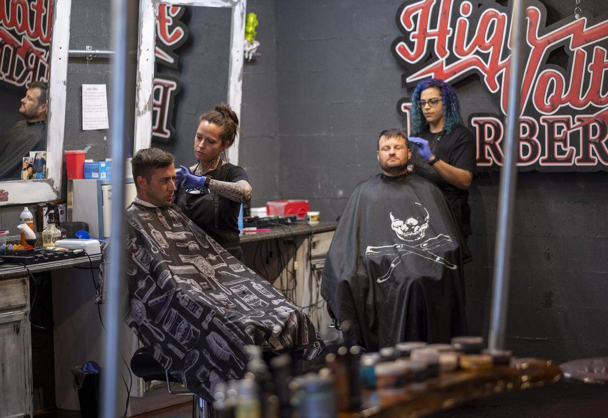 April Lanz (left) and Stina Arnold barber their final customer’s hair before closing shop at High Voltage Barbering in Socastee.More “non-essential” small businesses closed Wednesday in Myrtle Beach after S.C. Governor McMaster’s issued his latest mandate shuttering entertainment venues and massage and tattoo parlors and other places where customers come into close contact with workers. April 1, 2020.