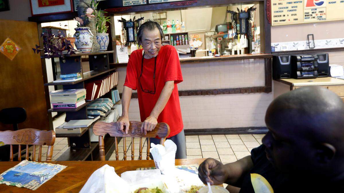 Frank Koo talks with customer Stephon Ogunduyilemi at Wok Express on North Kings Highway in Myrtle Beach, S.C., Friday, Sept. 14, 2018. 