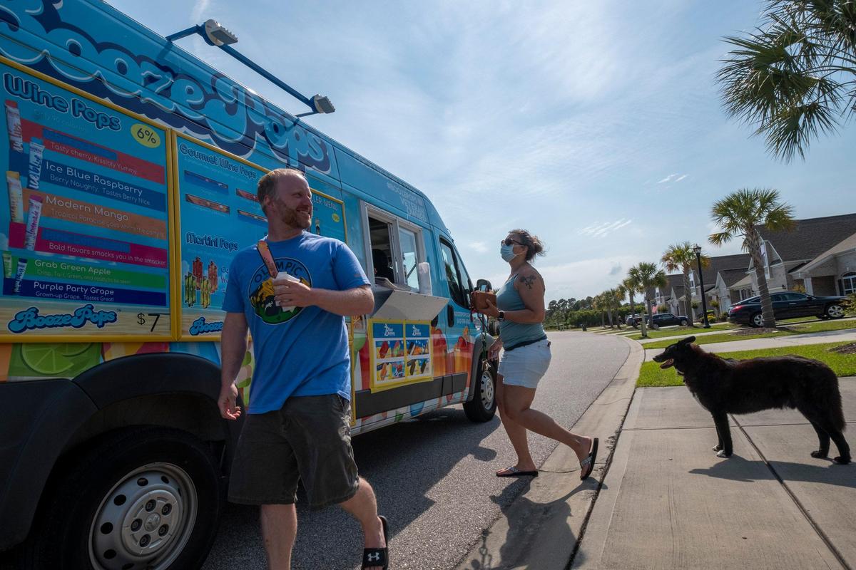 Neighbors gather around the Booze Pops truck when it makes a stop in the Forestbrook community of Tuscany on Cinco de Mayo. With most of the spring events canceled in the Myrtle Beach area, the Booze Pops truck has been making the rounds of local communities, “bringing the bar” to people stuck at home. May 5, 2020