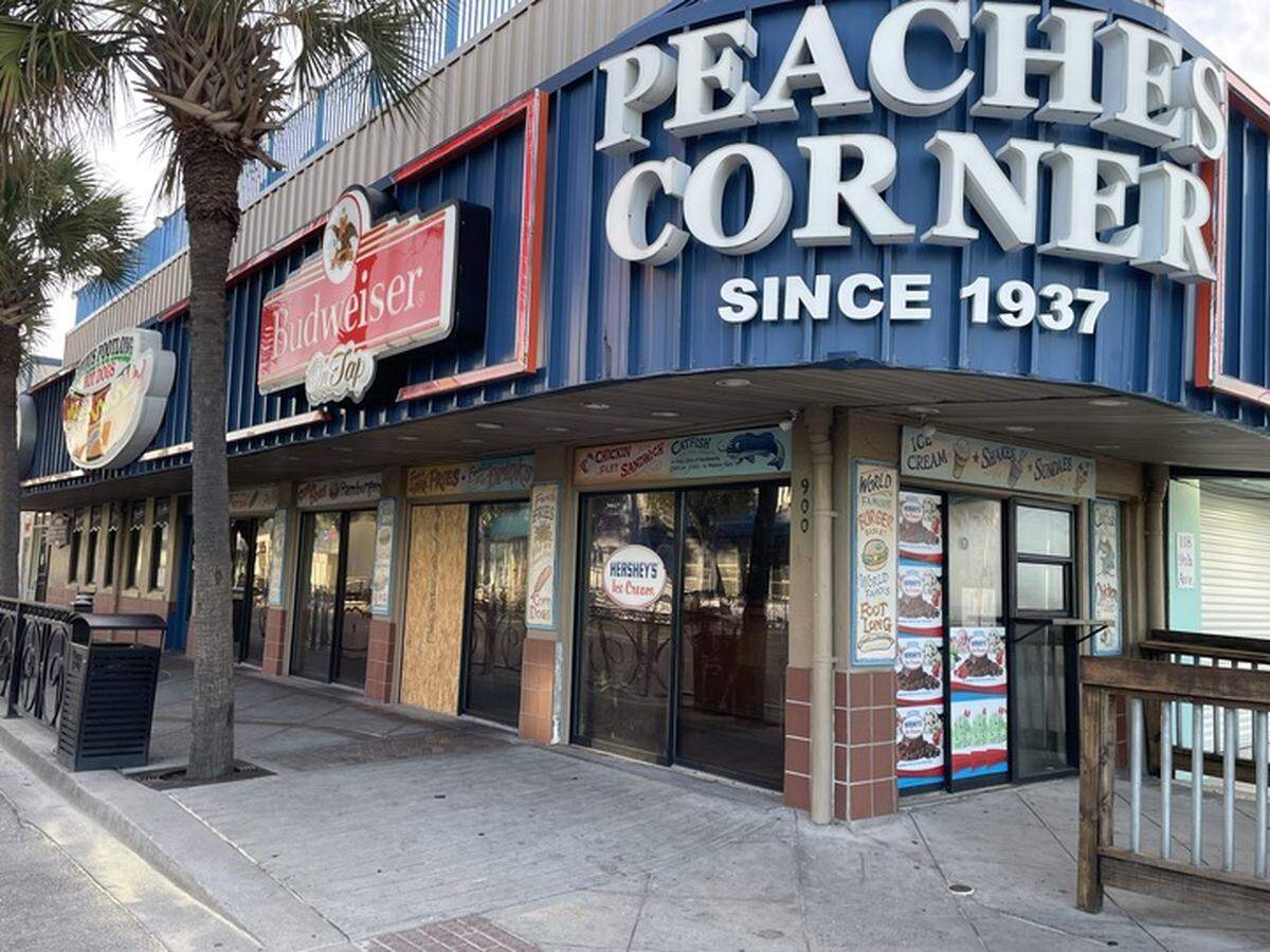 The door of Peaches Corner was boarded up Saturday morning after a shooting Friday, June 27, 2025, between a restaurant employee and customer left one person dead. June 28, 2025.
