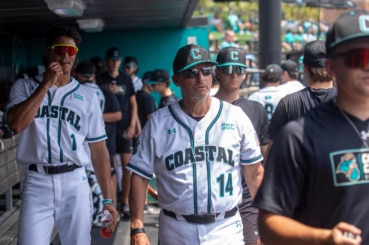 Coastal Carolina Coach Gary Gilmore cheers on his players from his customary place in the dugout at Spring Brooks Stadium. Gilmore is retiring after 39-years of coaching. April 20, 2024.