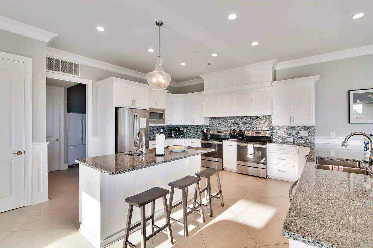 The Carlisle kitchen. It has two stoves, two dishwasher, a large refrigerator and 10 barstools.