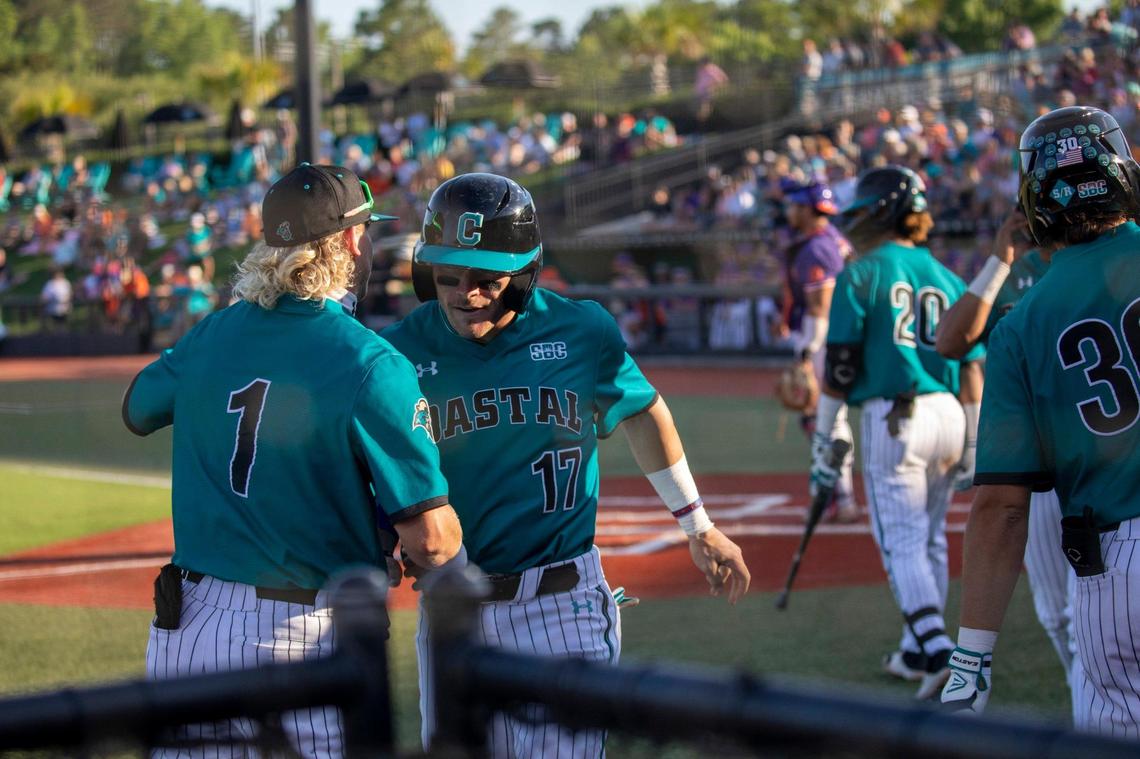 Coastal teammates celebrate as runners cross the plate early in the game against Clemson. The Coastal Carolina Chanticleers played the Clemson Tigers NCAA baseball Tuesday at Springs Brooks Stadium in Conway, SC. May 17, 2022.