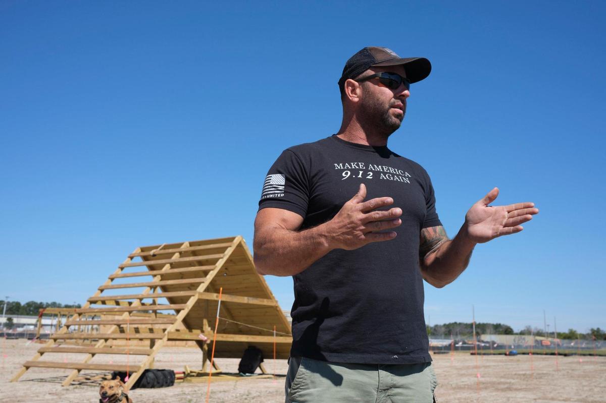 Ryan Small, owner of Beast Ninja Gym, along with his dog “Gunner” demonstrate some of the 30 obstacles he’s built for the Myrtle Beast All Terrain Race planned for May 21, 2022. The three-mile course with obstacles and physical challenges is being built on the site of the former Hard Rock Park off George Bishop Parkway. March 14, 2022.