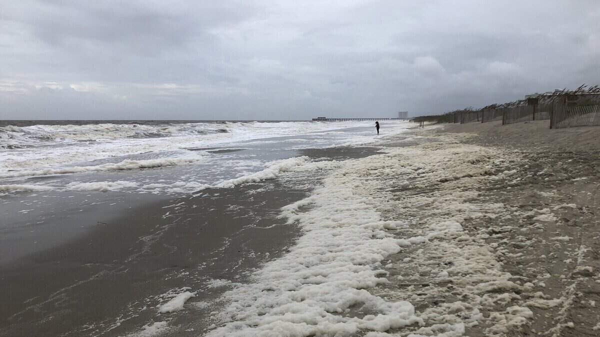 Sea foam washes ashore near Springmaid Pier.