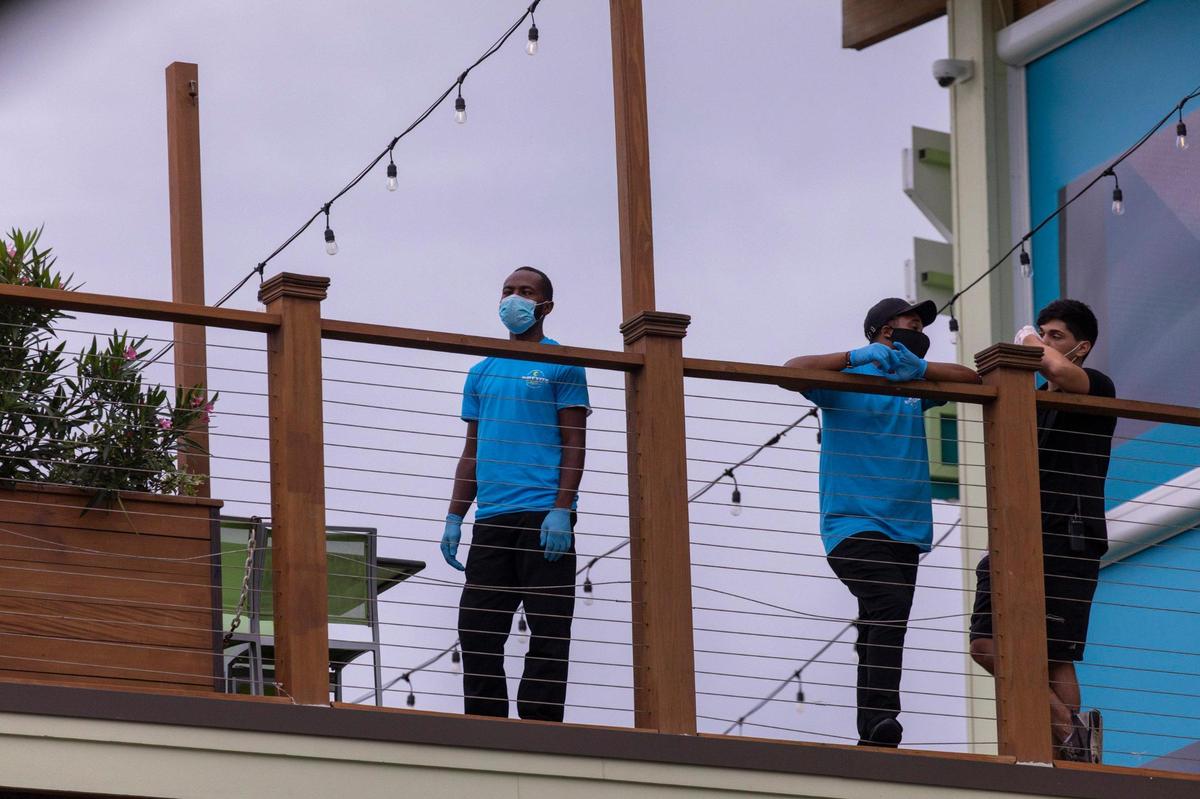 Restaurant workers wait on customers at RipTydz on Tuesday evening. After a busy holiday weekend in which the City of Myrtle Beach enacted mask regulations to combat the coronavirus pandemic, Ocean Boulevard and area attractions were relatively quiet on Tuesday, July 7, 2020.
