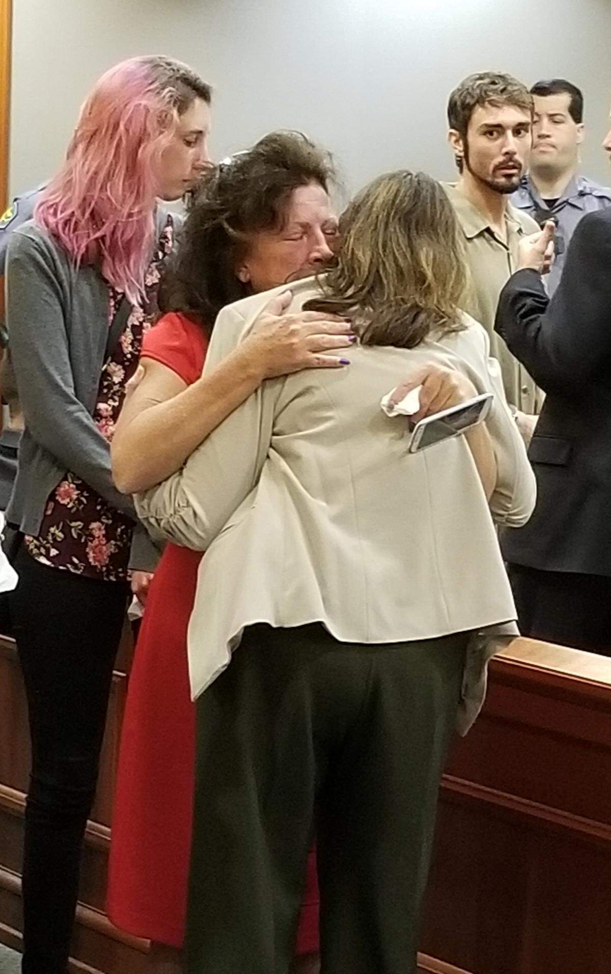 Sheila Barger (red) hugs Patricia Hale following a court hearing. Hale pleaded guilty to charges in connection to a drunken car crash that killed Barger’s daughter Samantha Herzig.