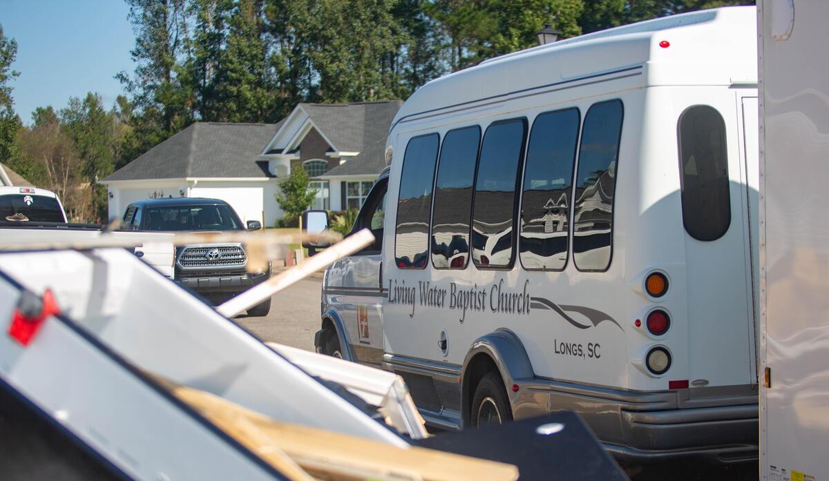 A Living Water Baptist Church van can be seen sitting in front of a home Monday as church members help Polo Hills residents begin the arduous task of restoring their homes after the storm.