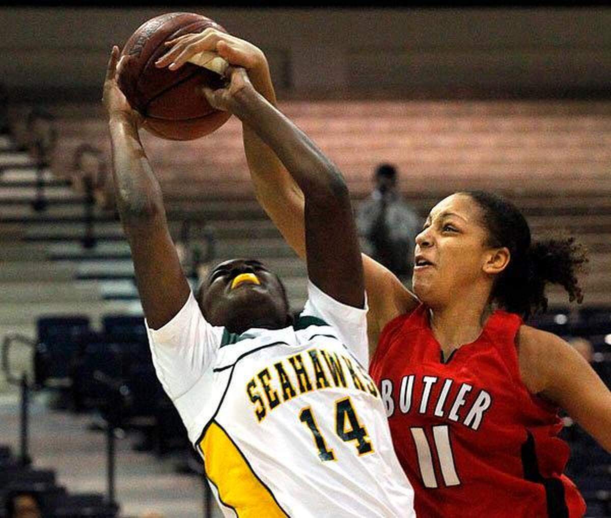 Butler’s Cierra Burdick, 11, fouls Myrtle Beach sophomore Khadijah Sessions, 14, during first-half action Dec. 18, 2009, during the opening day of the 11th annual Crescent Bank Holiday Invitational at the Myrtle Beach Convention Center in Myrtle Beach. Butler defeated the Seahawks 54-45 during first-round action.