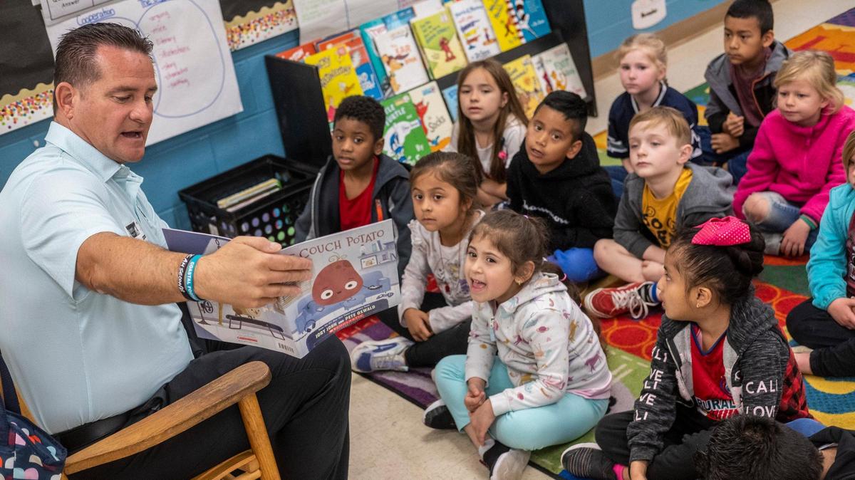 Coastal Carolina University football coach Tim Beck reads to a Kindergarden class at Palmetto Bays Elementary School. Eighty-six Coastal Carolina athletes visited 86 local Kindergarden classrooms to read the book “Couch Potato” by Jory John on Wednesday as part of The United Way of Horry County’s “Caring For Kindergardener’s” initiative. The program was started in 2003 with former football coach David Bennett. March 1, 2023.