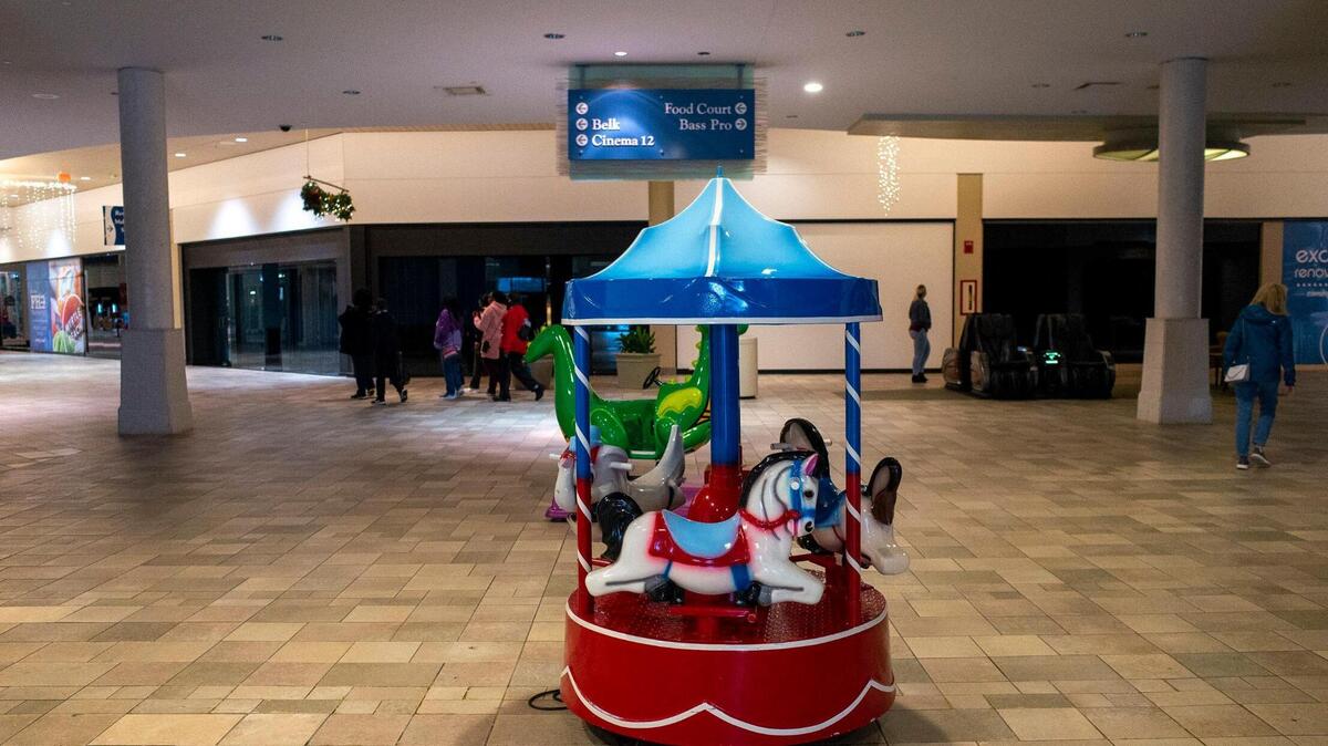 Despite being the shopping season, few people walk the halls of the Myrtle Beach Mall where many shops lie shuttered. In the hall where this toy ride sits, lights flicker, giving the mall a long-abandoned feel. Long term plans to demolish most of the existing mall to create more modern outdoor shopping experience have yet to materialize for years. Dec. 21, 2021.