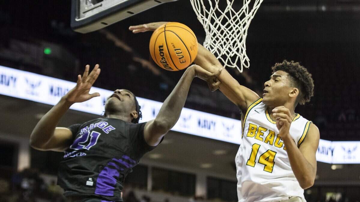 Ridge View’s Ja’Von Benson is blocked by Myrtle Beach’s JJ Jones after he recovered the ball in the class 4A championship game at the Colonial Life Arena on Saturday.