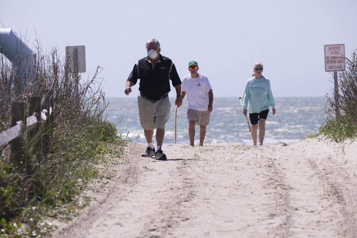 James Gephardt and Terry and Susan Ritchie came down to the beach in North Myrtle to take a look after access opened on Tuesday. North Myrtle Beach opened public beach accesses after Governor Henry McMaster removed his order allowing local municipalities to make their own decisions as of noon on Tuesday. April 20, 2020