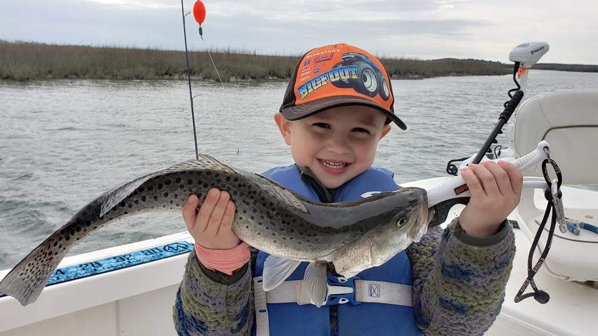 Hunter Connolly, 5, shows off a 20-inch spotted seatrout he caught while fishing with his dad, Capt. Dan Connolly of O-Fish-Al Expeditions, in Murrells Inlet on Sunday.