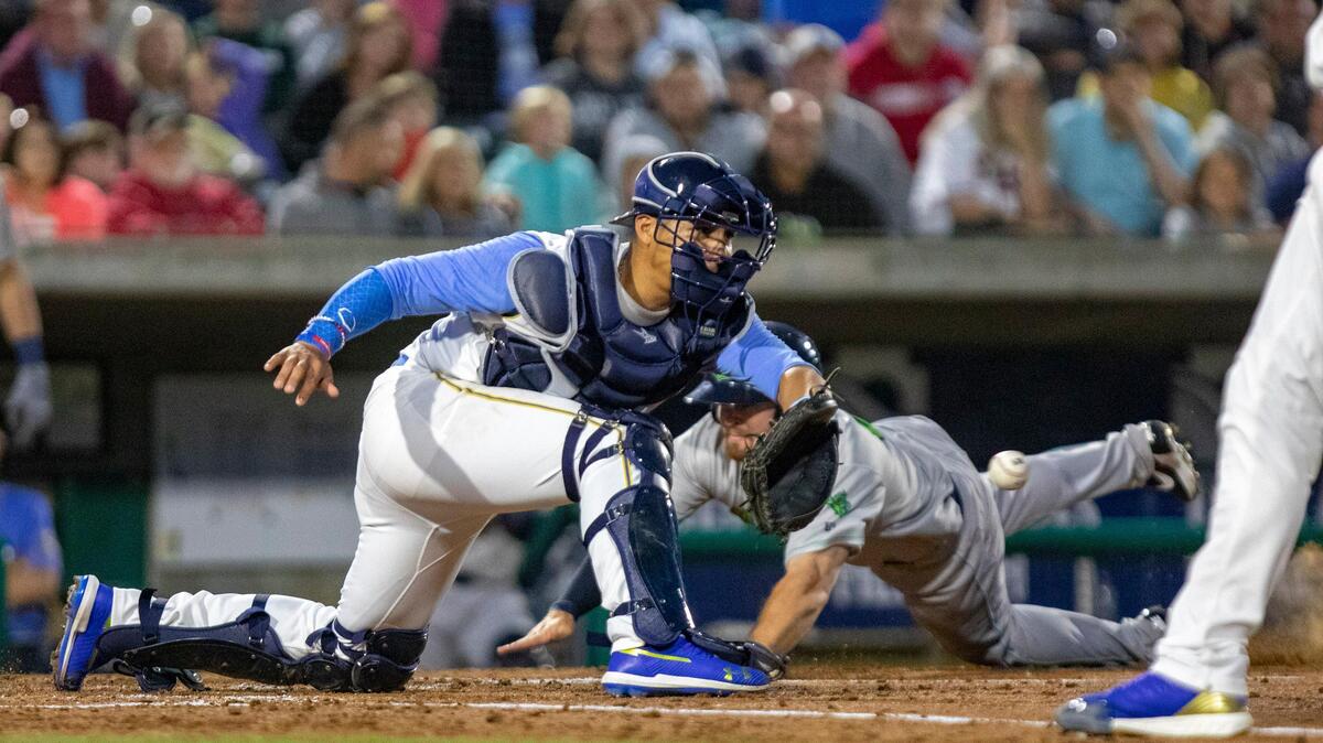 Myrtle Beach Pelicans catcher Miguel Amaya awaits the ball as a runner slides into home plate in the Pelicans’ opening day game against the Lynchburg Hillcats Thursday evening in Myrtle Beach. Lynchburg won 14-5 in front of a sellout crowd of 6,599 at Pelicans Ballpark.