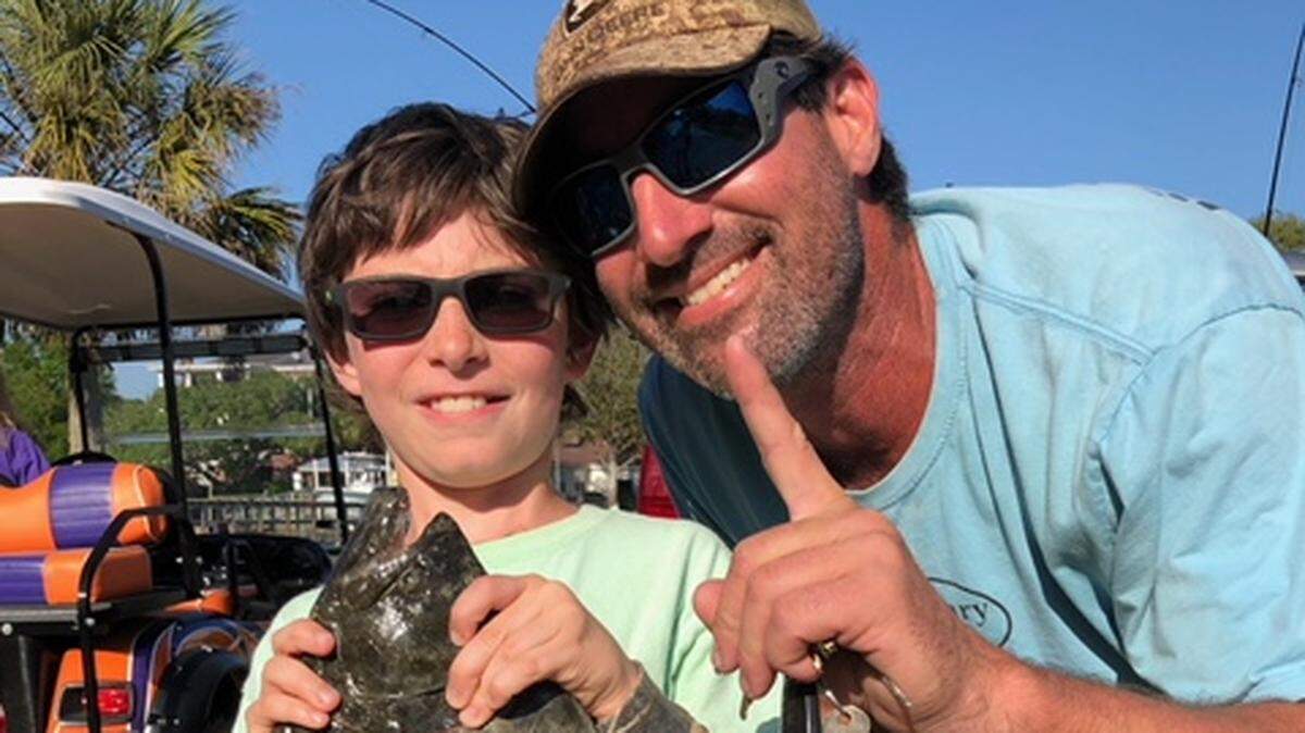 Cullen Gerace and his dad, Peter Gerace show off the 4.1-pound flounder the nine-year-old caught to win the Grand Strand Saltwater Anglers Association Spring Flounder Tournament last Saturday.