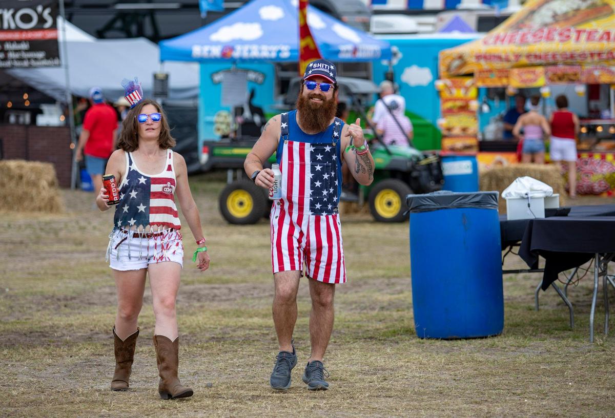 Brad Hansley and Laura Waters of Pinehurst, N.C. show off their American flag-themed attire Friday afternoon on day 2 of Carolina Country Music Fest in Myrtle Beach.