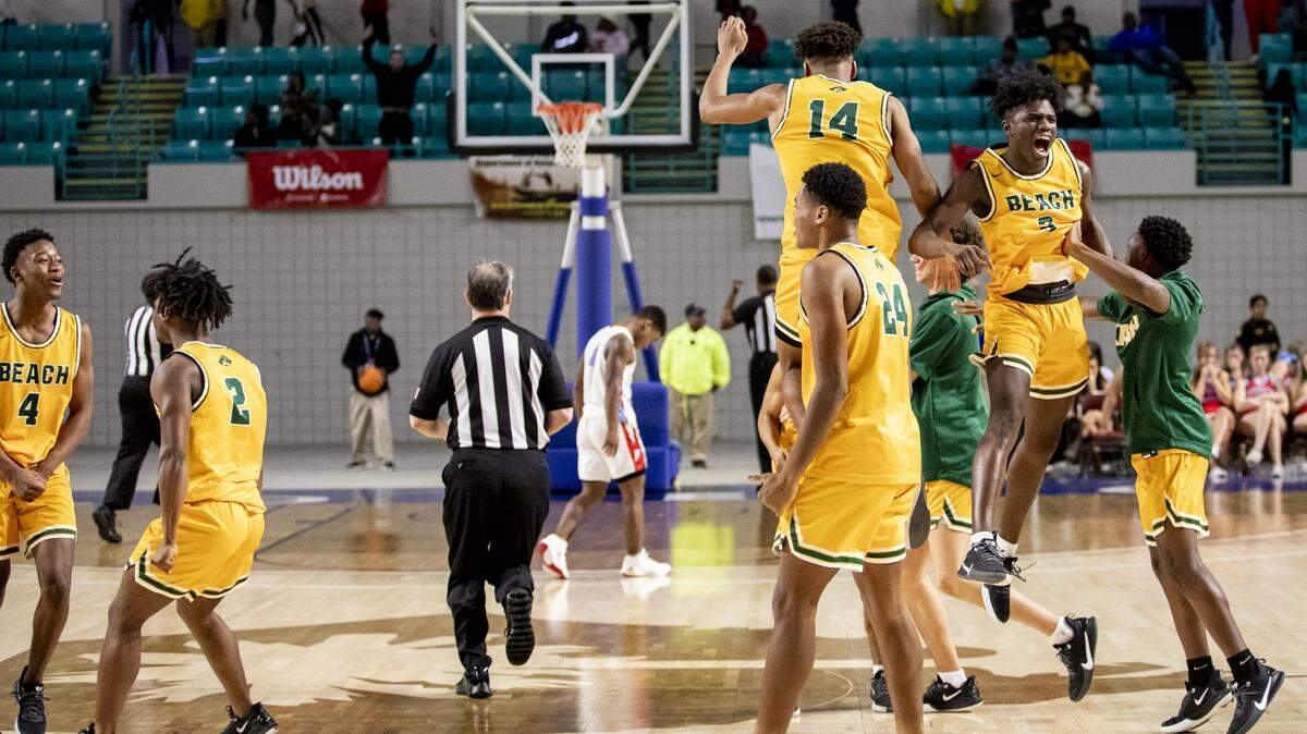 Myrtle Beach junior forwards J.J. Jones (14) and Qwalique Burgess jump in celebration after the Seahawks defeated A.C. Flora 68-59 at the Florence Center in Florence, S.C. to advance to the state championship game. The Seahawks will play the winner of Ridge View-Wren.