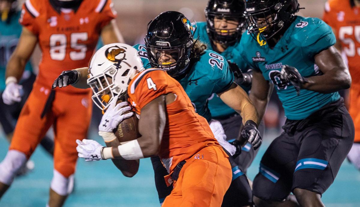 Campbells Bryant Barr gets tackled by Silas Kelly by Coastal’s Silas Kelly. Coastal Carolina University football hosted Campbell during it’s 2020 home-opening game at Brooks Stadium in Conway, SC. on Friday night. September 18, 2020.