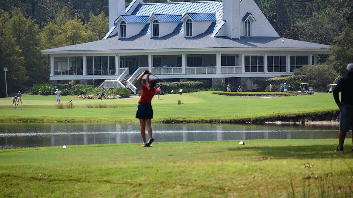 A college golfer hits a tee shot toward the clubhouse at True Blue Golf Club in Pawleys Island on Monday during the Golfweek Program Challenge tournament, which concluded Tuesday.