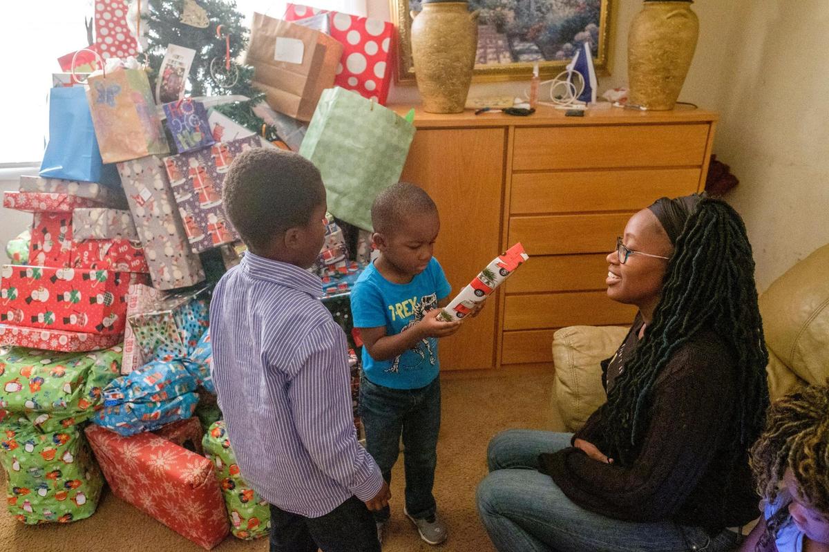 Shanita Davis, talks with her sons Eli and Ezekiel Davis, ages 6 and 4, about their hopes for Christmas. Davis, struggling to provide gifts for her five children for Christmas, reached out to her community on the internet for help. The response has been overwhelming with gifts pouring in to her Socastee apartment. Dec. 22, 2021.