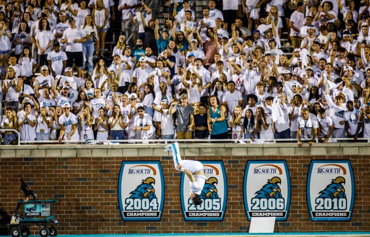 The student section goes wild as a cheerleader does flips across the end zone. Coastal had the national spotlight with an ESPN2 audience and a record crowd of 17,697, and the Chants took advantage of them with a 49-22 win over Kansas on Friday night at Brooks Stadium. Aug. 11, 2021.
