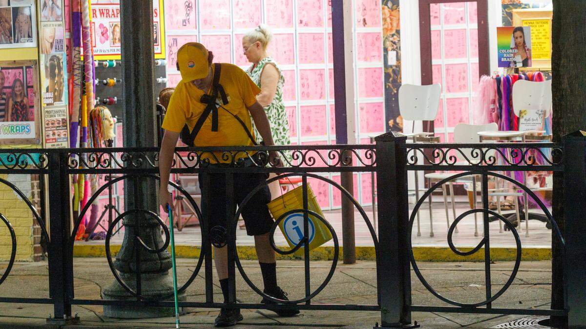 One of Myrtle Beach’s Gold Cap Ambassadors picks up trash along Ocean Boulevard on Friday evening. Downtown Myrtle Beach’s tourist district was relatively quiet for a Summer evening on Ocean Boulevard and the Boardwalk. Storms put a damper on the evening activities but as the skies cleared, visitors returned to enjoy the attractions. Friday, May 30, 2025.