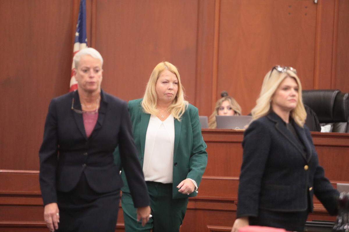 Lawyers Mary-Ellen Walter, Aimee Jendrzejewski Zmroczek and Leigh Andrew Waller walk back from speaking with Judge B. Alex Hyman during Chris Dontell’s trial. Walter and Waller are the prosecutors and Zmorczek represents the defendant.