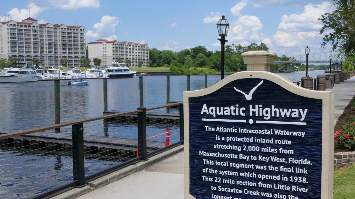 A sign at Barefoot Landing in North Myrtle Beach explains the history of the Intracoastal Waterway. May 29, 2024.