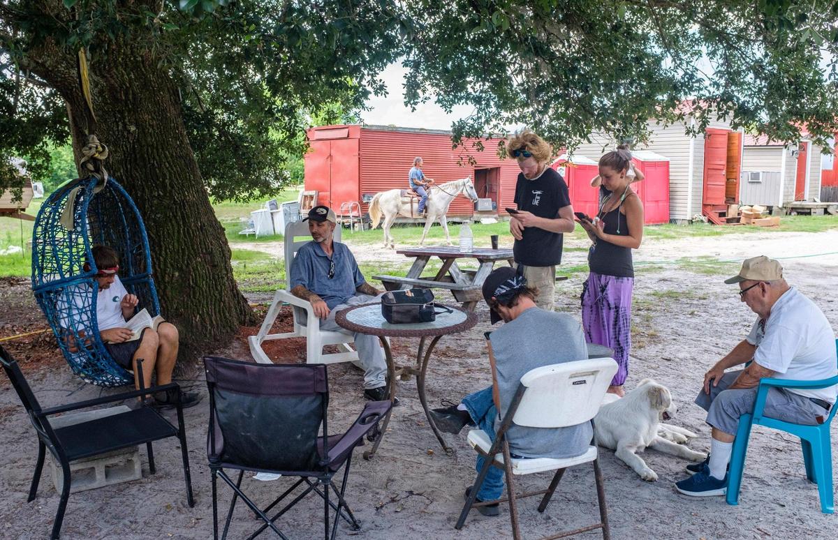 Residents gather for Bible study at the Recovery Ranch, a living facility for those struggling with homelessness, mental illness and drug addictions. The facility has come under fire by county officials for code violations and the volume of 9-11 calls. According to the founder, the facility could be shut down leaving approximately 75 residents with no where to go. July 1, 2021.