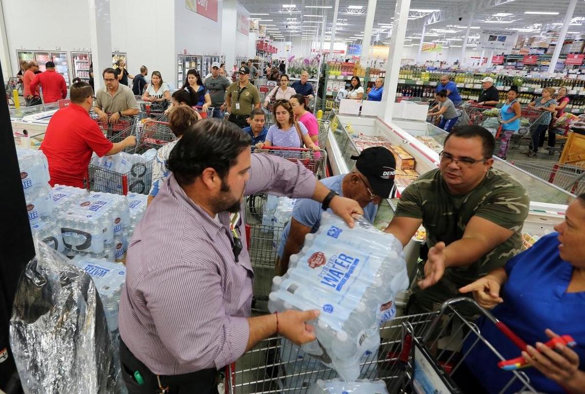 Residents purchase water at BJ Wholesale in preparation for Hurricane Irma Tuesday, Sept. 5, 2017, in Miami. Hurricane Irma grew into a dangerous Category 5 storm, the most powerful seen in the Atlantic in over a decade, and roared toward islands in the northeast Caribbean Tuesday on a path that could eventually take it to the United States. (Roberto Koltun/Miami Herald via AP)