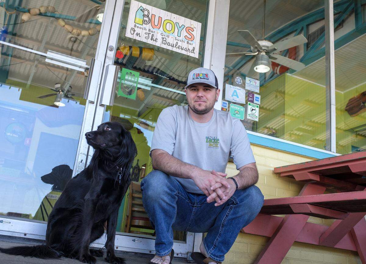 Weldon Boyd and his dog Grady watch diners come to order at Buoy's on the Boulevard in North Myrtle Beach. April 28, 2020
