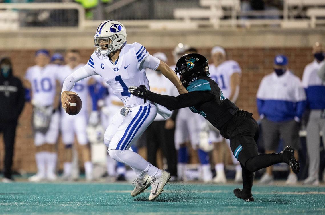Brigham Young’s Zach Wilson is brought down by a Coastal defender. Coastal Carolina, ranked #14, won 22-17 over #8 ranked Brigham Young University on Saturday night. Coastal remains undefeated. December 5, 2020.