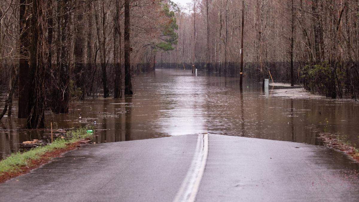 The water line from Hurricane Florence’s 2018 flood still shows in the trees as the February 2020 flood covers Landing Road in Bucksville. Rising floodwaters have closed roads and threatened homes throughout Horry County, SC on Wednesday. February 19, 2020.