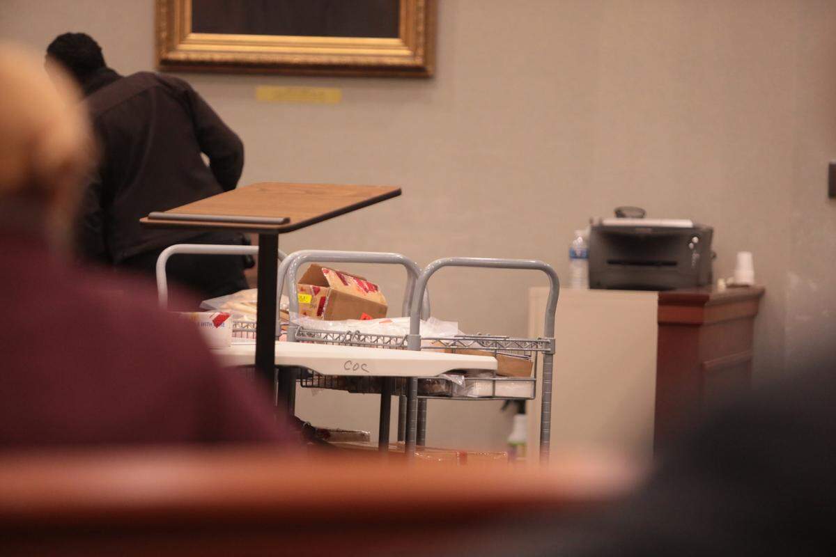 A cart of what appears to be evidence for Christopher Dontell’s murder trial. The trial was cut short after he plead guilty to two charges and had his murder and accessory to kidnapping charges dropped.
