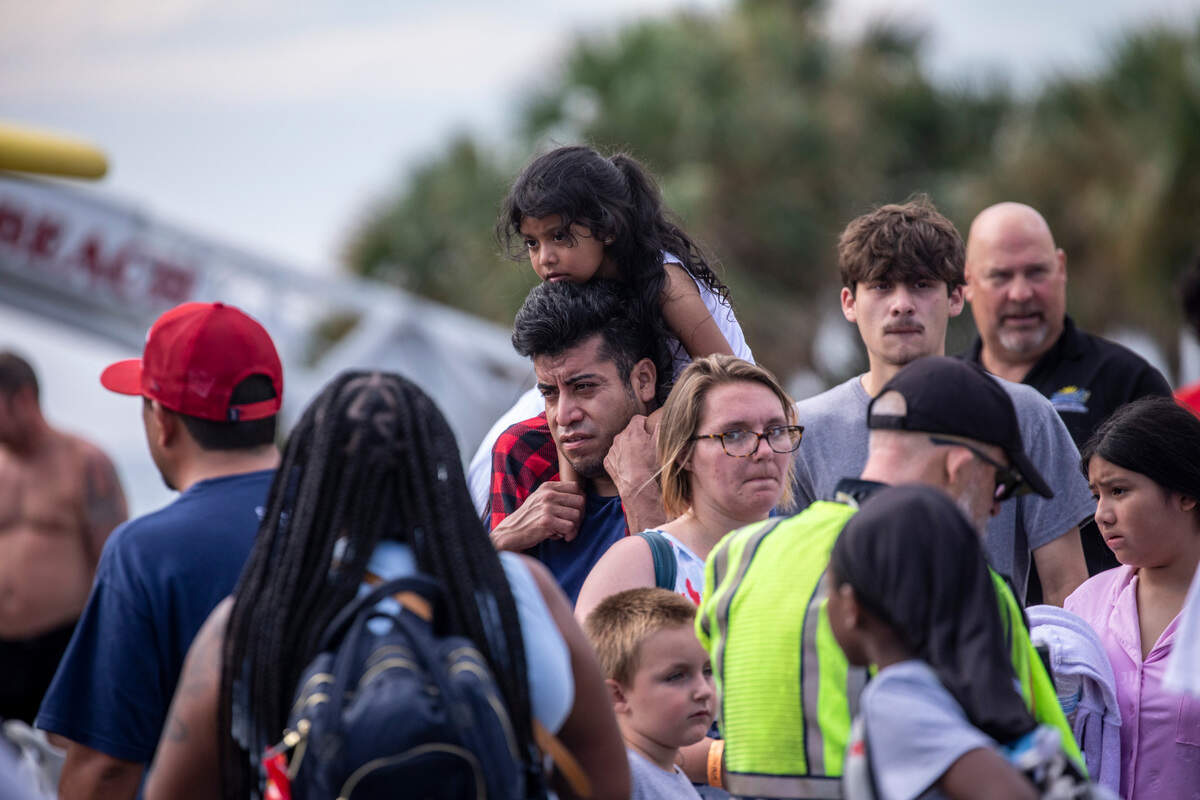 Displaced visitors gather to load onto buses after being evacuated from the Captain’s Quarters Resort in Myrtle Beach after a fire broke out on Monday morning. There were no injuries reported among guests but at least three firefighters were treated for dehydration. Aug. 16, 2023.